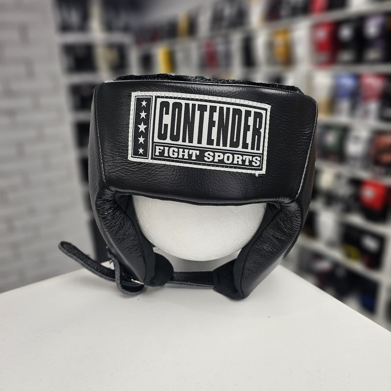 Black boxing headgear with 'Contender Fight Sports' logo on a mannequin head, blurred shelves in the background.