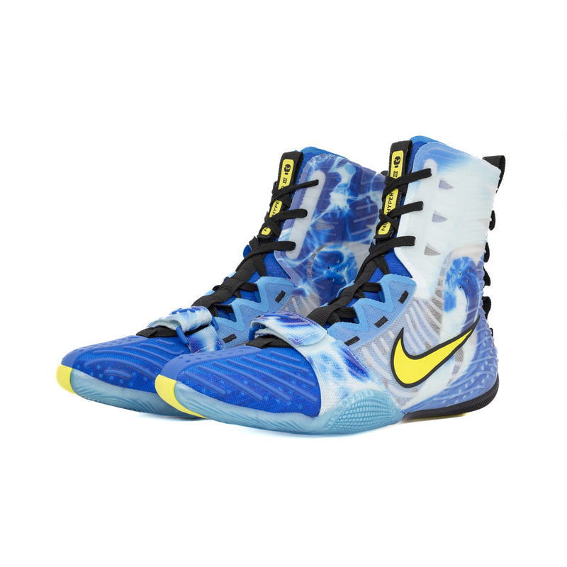 Blue and white athletic shoes with a yellow Nike logo on a white background