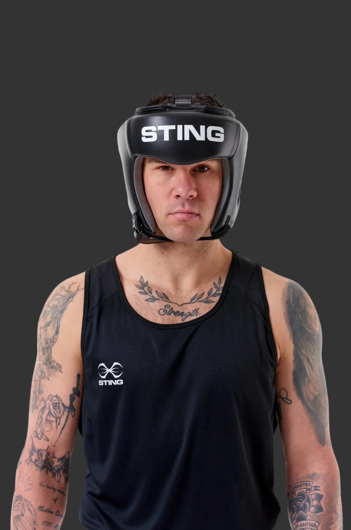 Person wearing a black 'Sting' boxing helmet on a white background