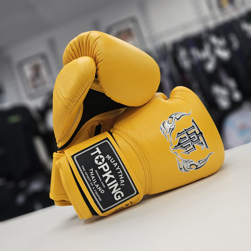 Yellow boxing glove with Top King branding on a blurred background