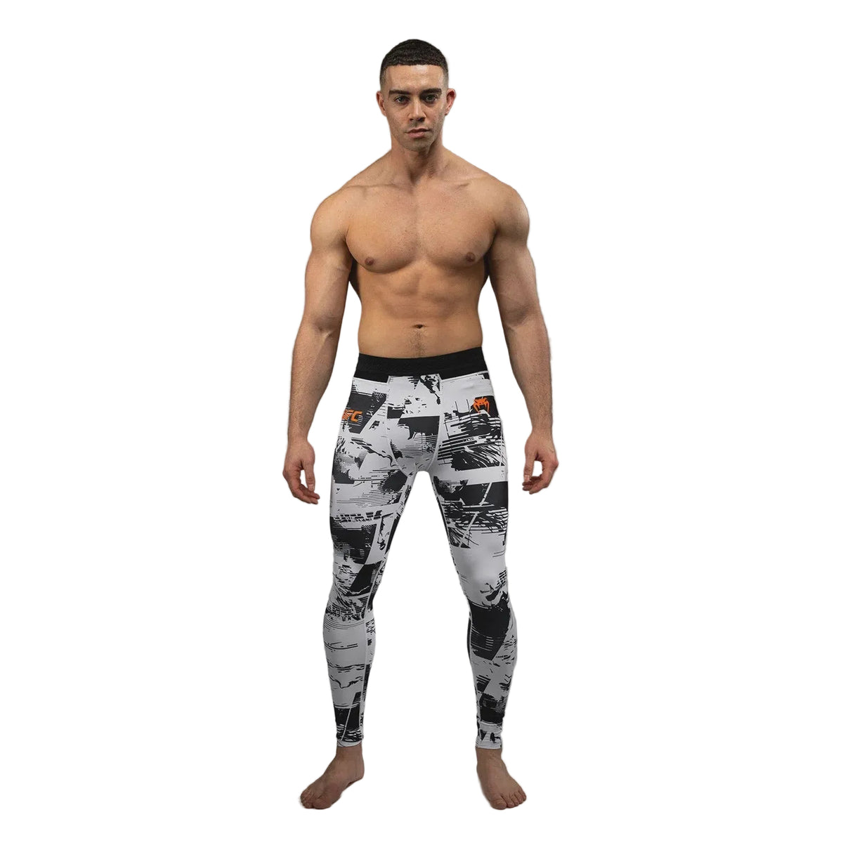 A shirtless male model stands against a gray studio background wearing high-waisted athletic leggings with a black, white, and gray abstract collage print and a black waistband.