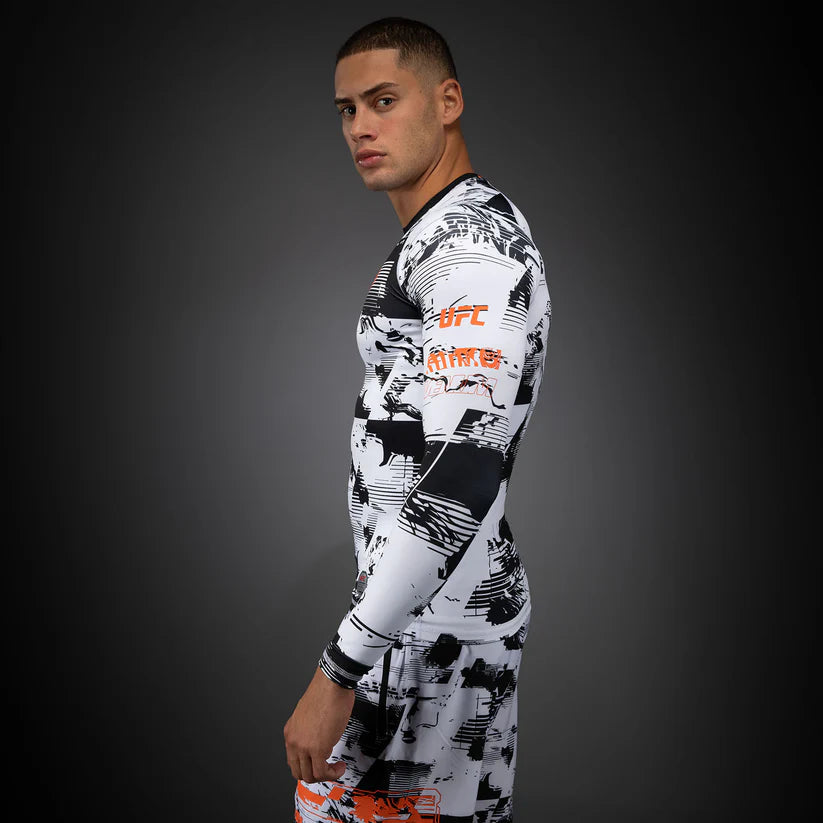 Person wearing a UFC branded compression shirt on a dark background