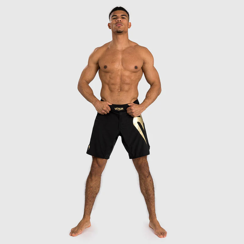 Man wearing black shorts with a logo on a white background