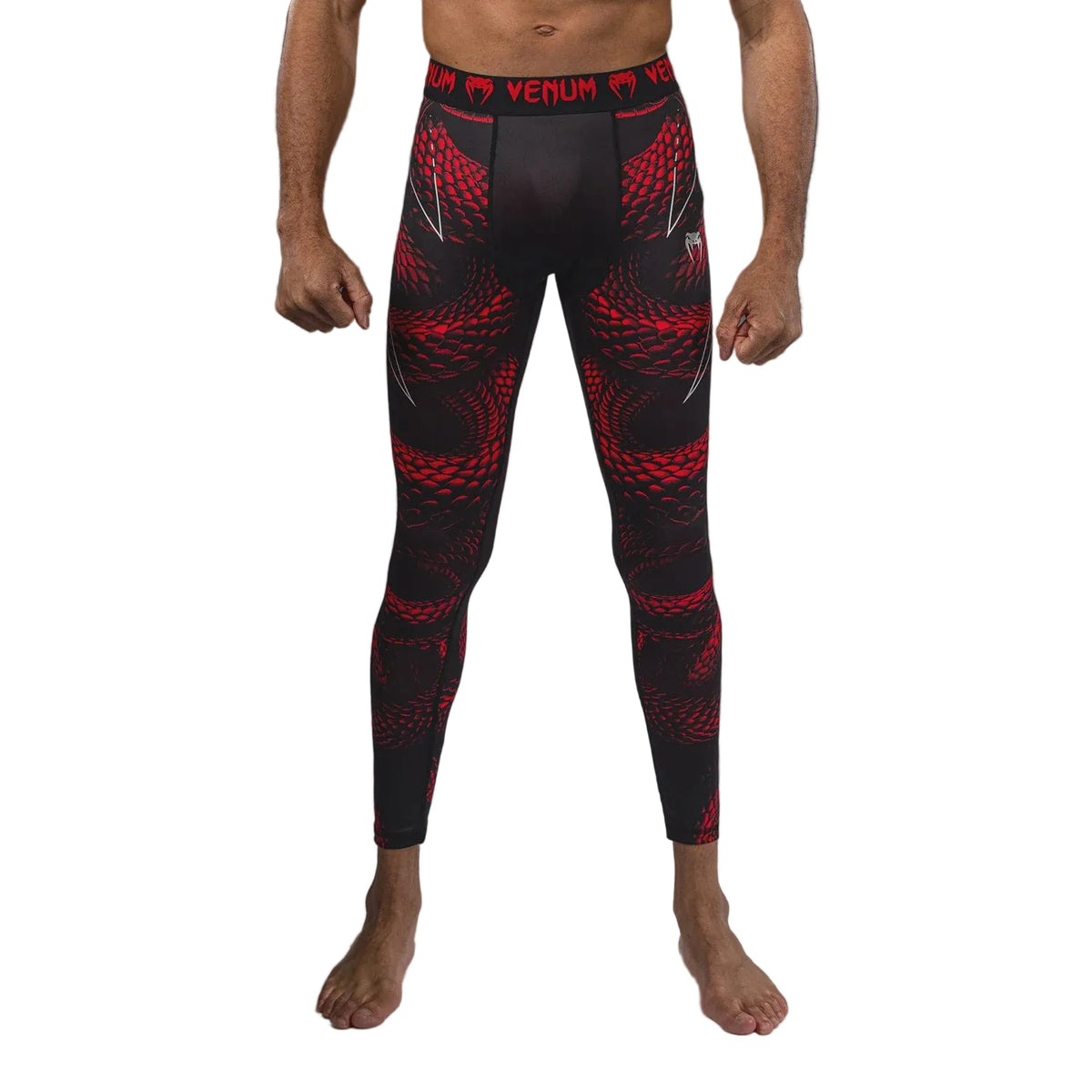 Black and red compression leggings with Venum branding on a gray background