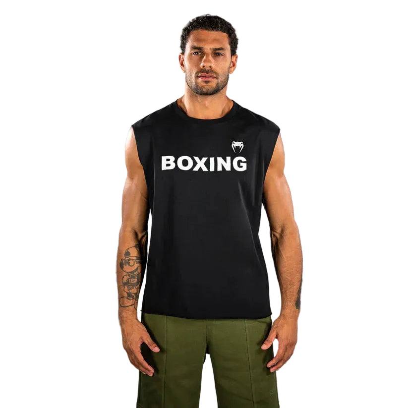 Man wearing a black sleeveless shirt with 'BOXING' text and logo on a gray background
