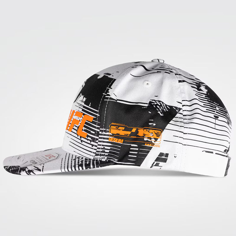 Cap with black and white pattern and orange text on a light gray background
